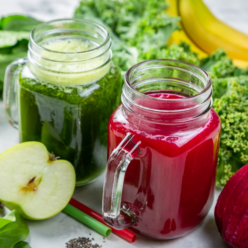 Alkaline diet concept – green and purple smoothies and ingredients